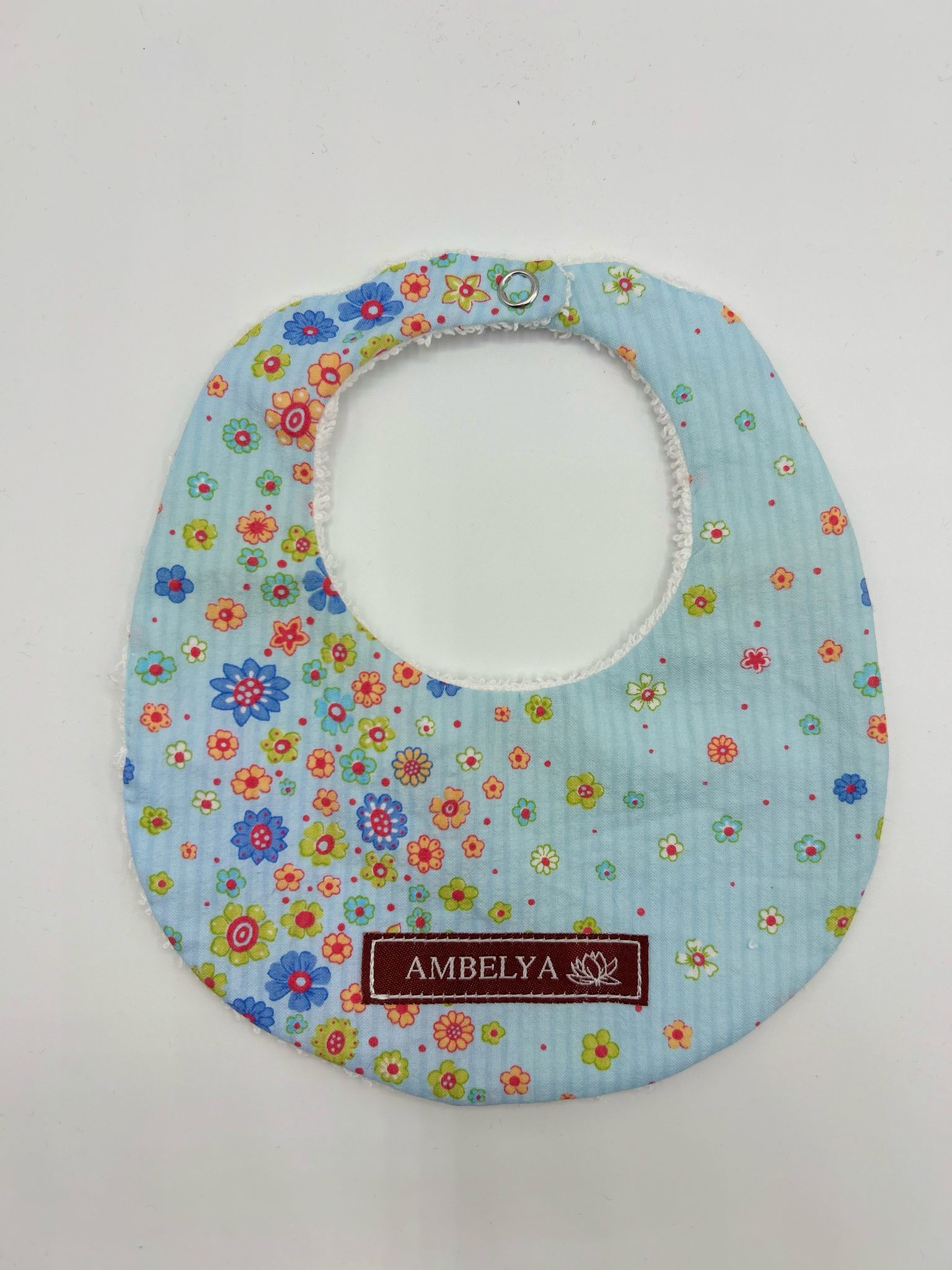 photo d'un bavoir bleu clair Ambelya pour enfant 